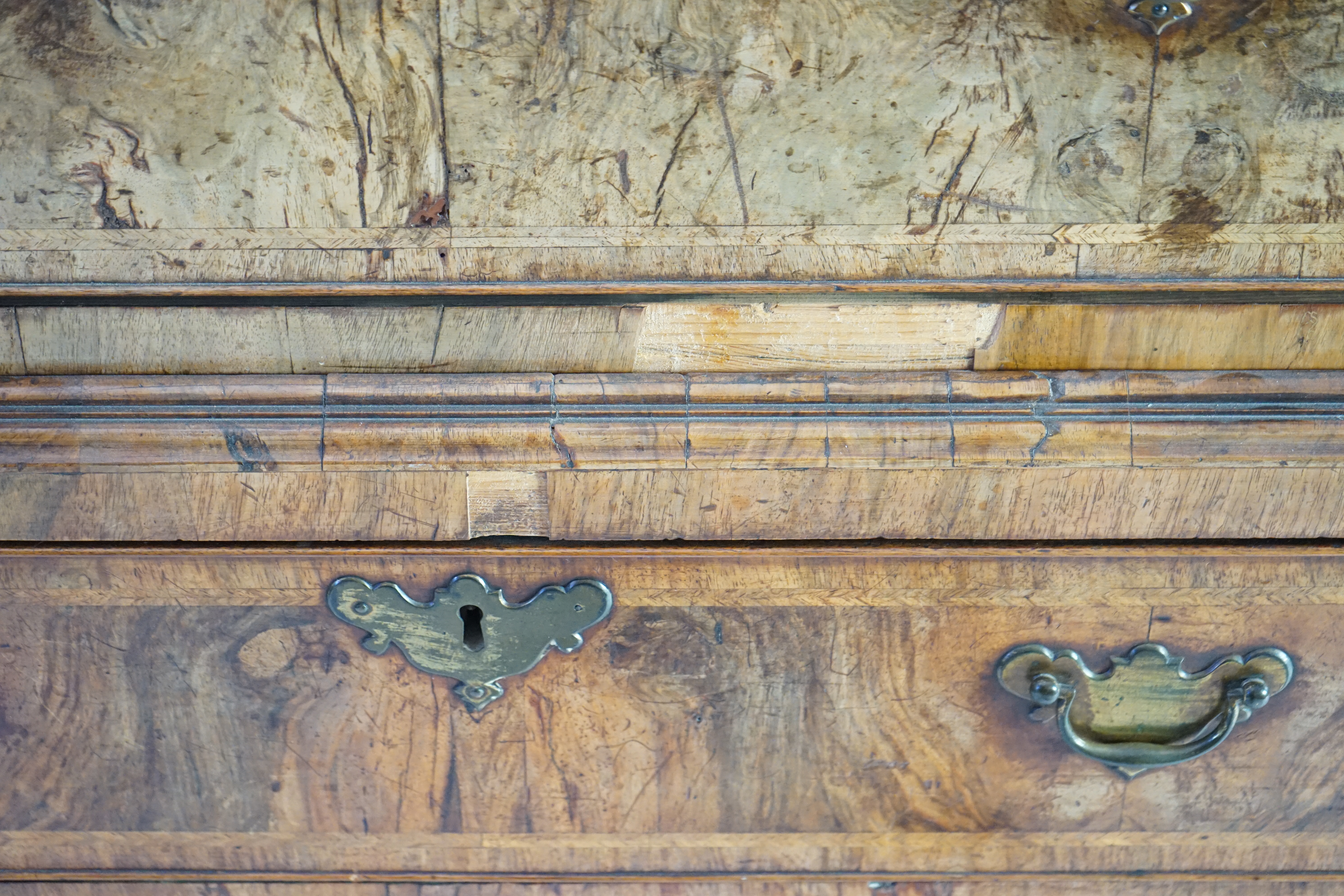 A George II feather banded walnut chest on chest